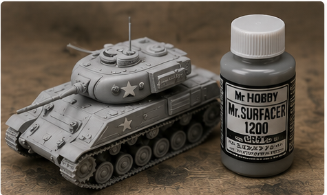 Primed scale model tank beside a bottle of model primer