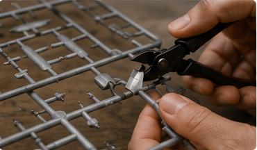Sprue cutters removing a plastic model part from a sprue